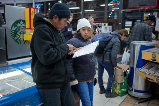 Ricardo Chub-Bo, 40, a refugee from Guatemala, and his daughter Rosa Maria, 14, prepare to take a Greyhound bus for Philadelphia