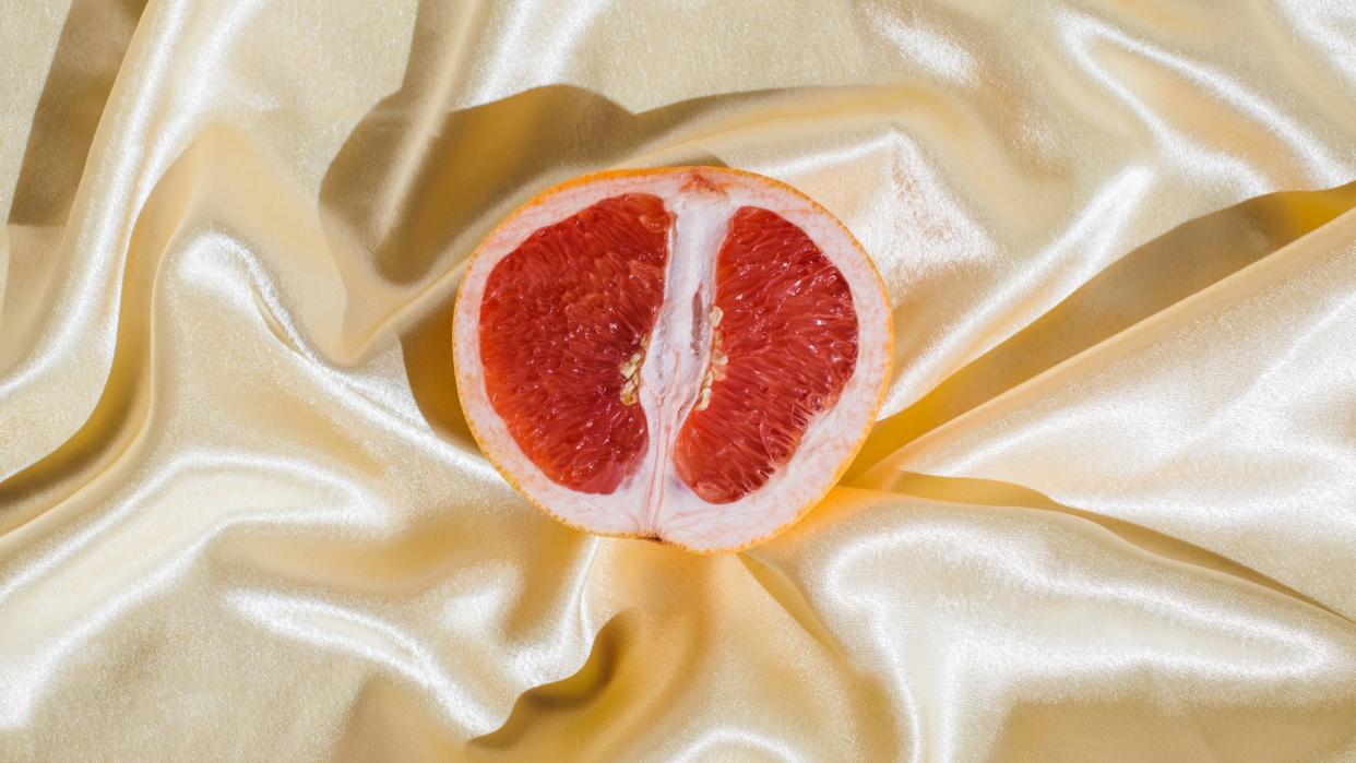  grapefruit on white satin sheets 