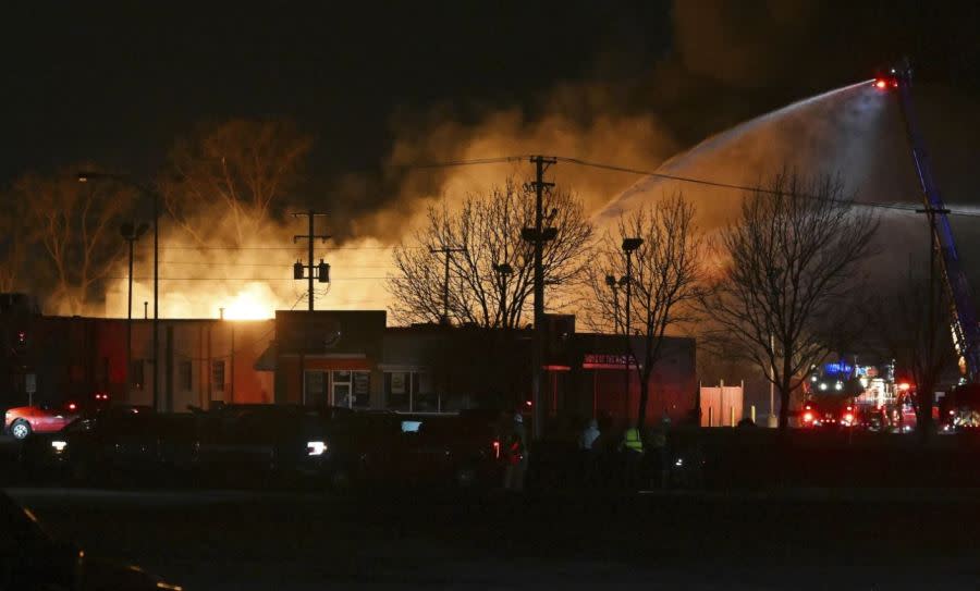 Fire departments battle an industiral fire in the Detroit suburb of Clinton Township on Monday, March 4, 2024. (Robin Buckson/Detroit News via AP)