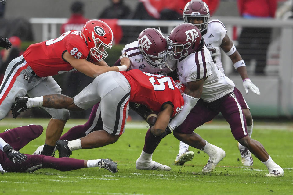 Nov 23, 2019; Athens, GA, USA; Texas A&M Aggies defensive lineman DeMarvin Leal (8) and linebacker Buddy Johnson (1) tackle Georgia Bulldogs running back Brian Herrien (35) during the first quarter at Sanford Stadium. Mandatory Credit: Dale Zanine-USA TODAY Sports