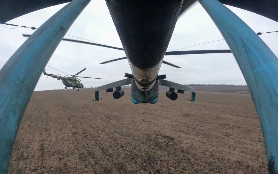 Ukrainian Mi-24 and Mi-8 helicopters fly towards Russian positions during a combat mission in Donetsk region - Evgeniy Maloletka/AP