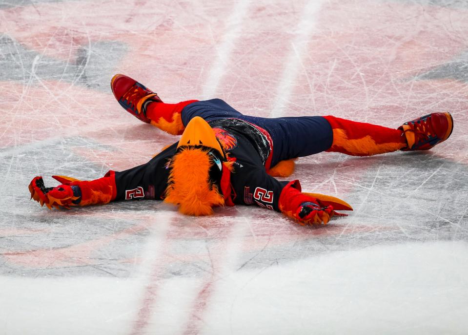 Fuego lays down on the ice in celebration of winning Game 6 of the Calder Cup Finals at Acrisure Arena in Palm Desert, Calif., Monday, June 19, 2023. 
