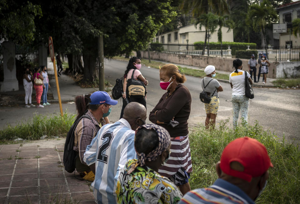 Relatives of those who were arrested during the July 11 protests, wait outside the court building where they are being tried, for the session to end, in Havana, Cuba, Tuesday, Jan. 11, 2022. Six months after surprising protests against the Cuban government, more than 50 protesters who have been charged with sedition are headed to trial and could face sentences of up to 30 years in prison. (AP Photo/Ramon Espinosa)