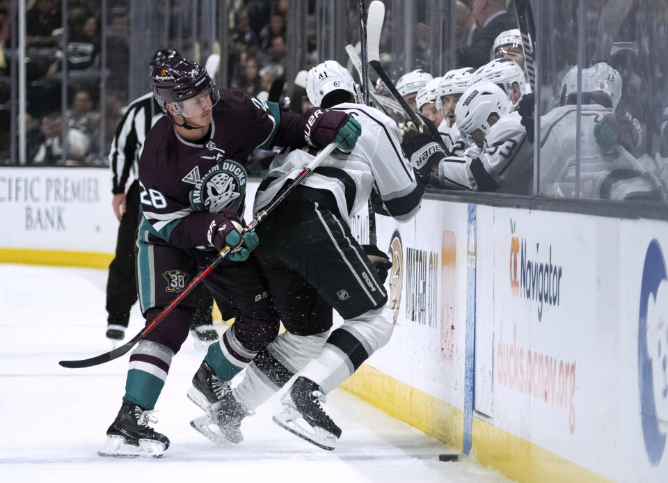 Anaheim Ducks defenseman Gustav Lindstrom (28) checks Los Angeles Kings center Akil Thomas (41) during the second period of an NHL hockey game Tuesday, April 9, 2024, in Anaheim, Calif. (AP Photo/William Liang)