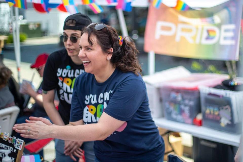 Cara Ellis, front, and Sarah Ratliff talk to festival goers at Pikeville Pride’s booth at the Hillbilly Days Festival in Pikeville, Ky., on Thursday, April 20, 2023.