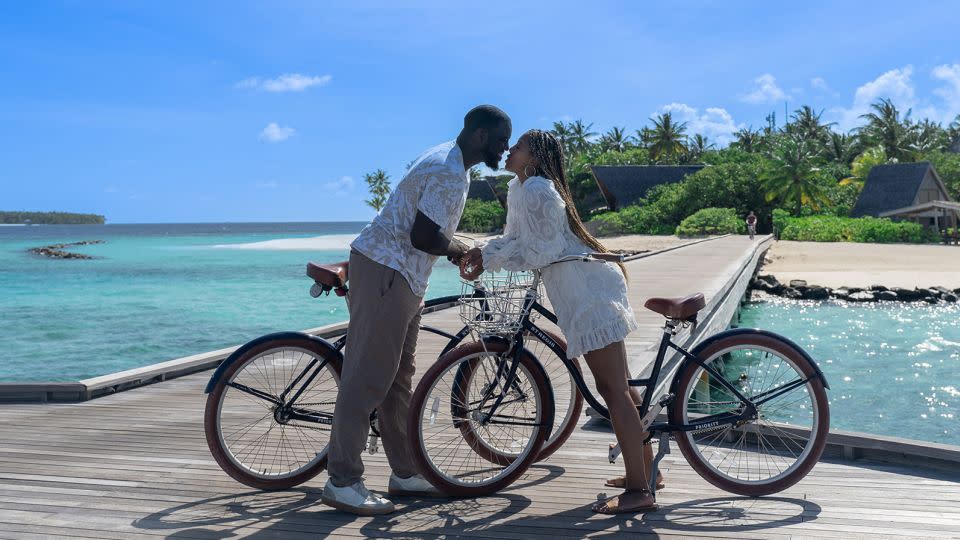 Leslie and Martina bonded over travel. Here they are cycling in the Maldives. - Martina Johnson and Leslie Johnson