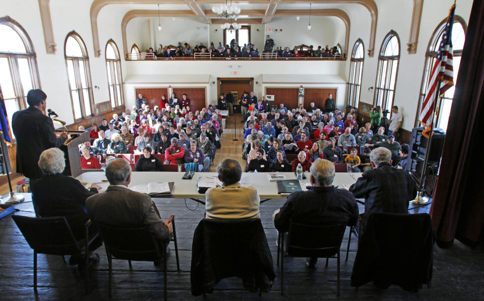 FILE - In this March 6, 2012, file photo, officials preside over the annual town meeting in Bethel, Vt. The COVID-19 pandemic is disrupting New England town meetings in 2021, a tradition where citizens gather to debate and decide on local issues. (AP Photo/Toby Talbot, File)