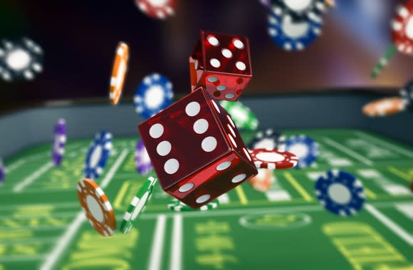 Dice and chips falling on a craps table.