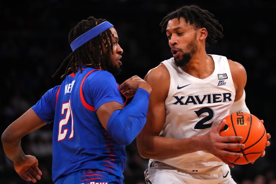 Xavier Musketeers forward Jerome Hunter (2) spins toward the basket as DePaul Blue Demons forward Da'Sean Nelson (21) defends in the first half of an NCAA college basketball game during the second round of the Big East conference tournament, Thursday, March 9, 2023, at Madison Square Garden in New York. 