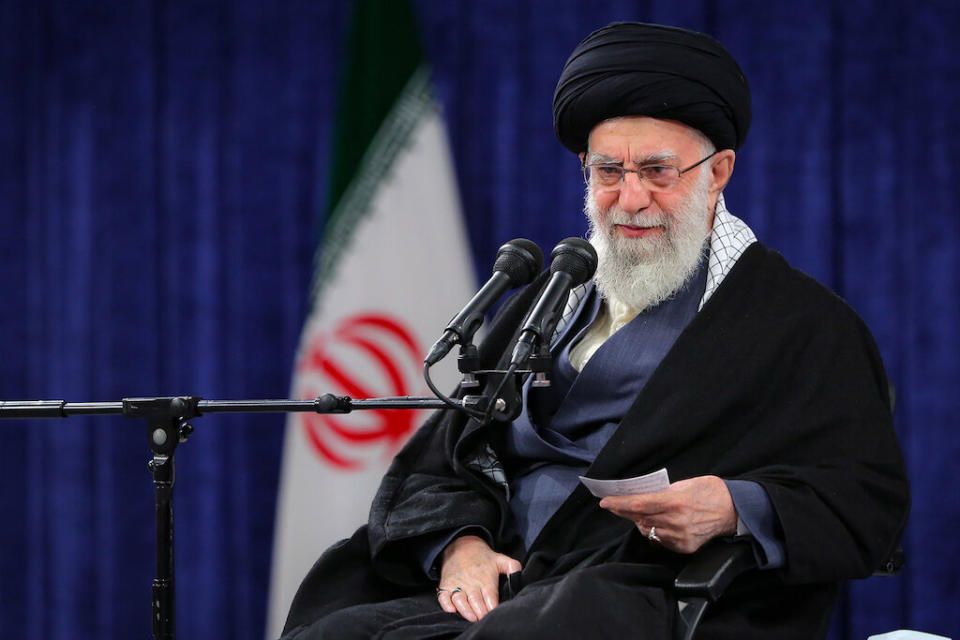 Supreme Leader Ali Khamenei at the microphone.