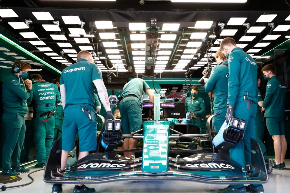 Mechanics work on the car of Aston Martin driver Sebastian Vettel (AP)