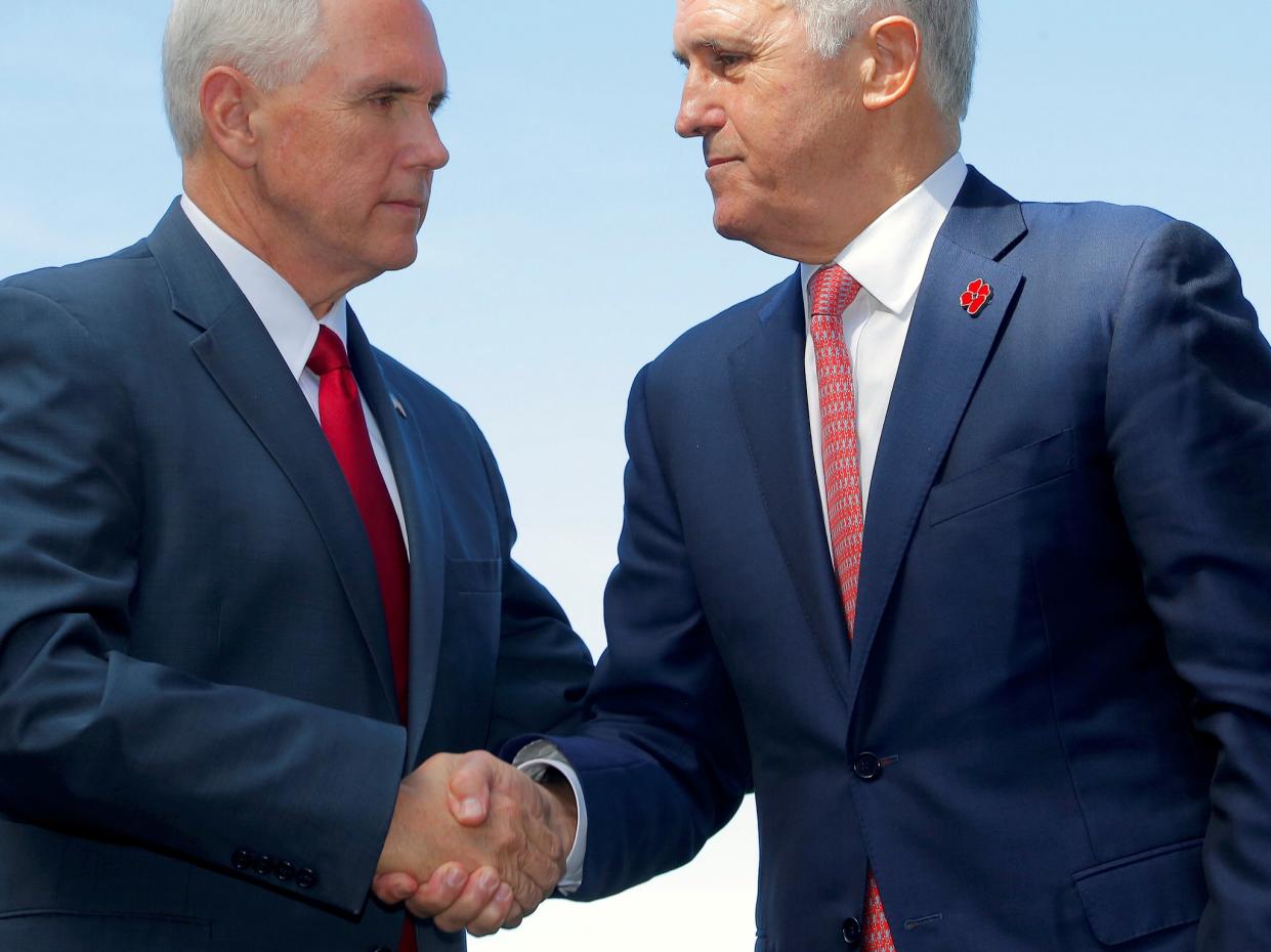 Mike Pence shook hands with Prime Minister Malcolm Turnbull after announcing a US commitment to the refugee resettlement deal: REUTERS