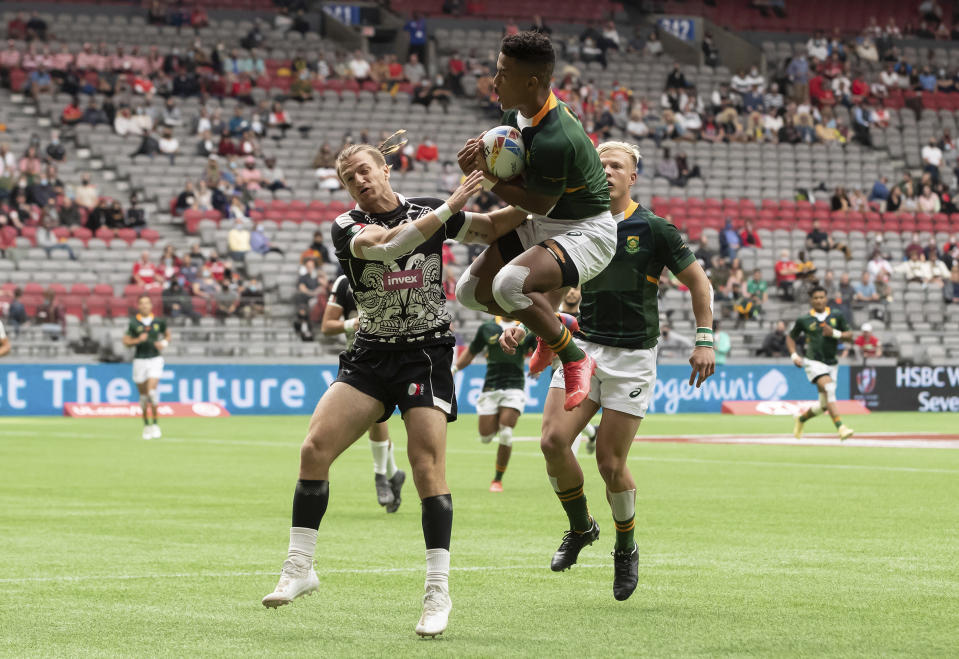 South Africa's Angelo Davids, front right, catches the ball in front of Mexico's Enrique Carmona and runs it in for a try during an HSBC Canada Sevens rugby game in Vancouver, British Columbia, Saturday, Sept. 18, 2021. (Darryl Dyck/The Canadian Press via AP)