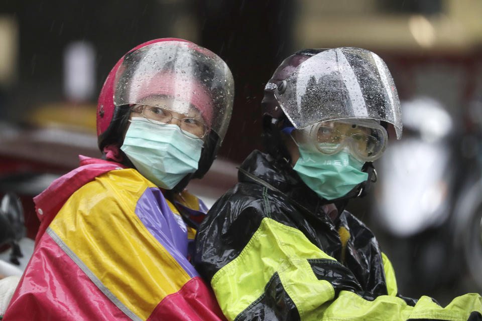 People ride a motorbike in the rain caused by Typhoon Chanthu in Taipei, Taiwan, Sunday, Sept. 12, 2021. Typhoon Chanthu drenched Taiwan with heavy rain Sunday as the storm’s center passed the island’s east coast heading for Shanghai. (AP Photo/Chiang Ying-ying)