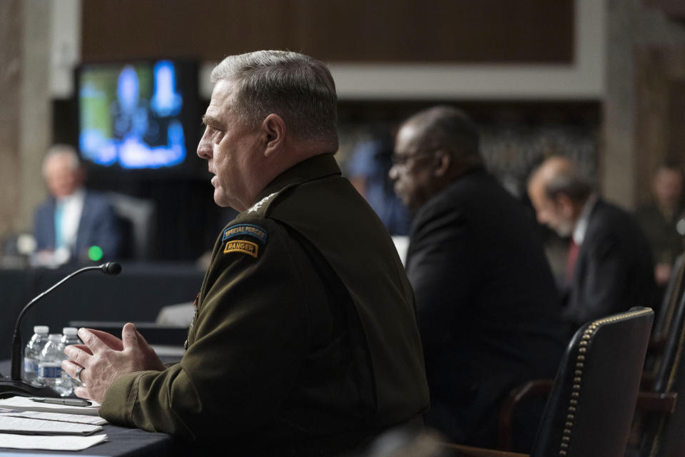 From left, Chairman of the Joint Chiefs of Staff Gen. Mark Milley, accompanied by Secretary of Defense Lloyd Austin, and Defense Under Secretary Mike McCord, speaks at a Senate Armed Services budget hearing on Capitol Hill in Washington, Thursday, June 10, 2021. (AP Photo/Andrew Harnik)