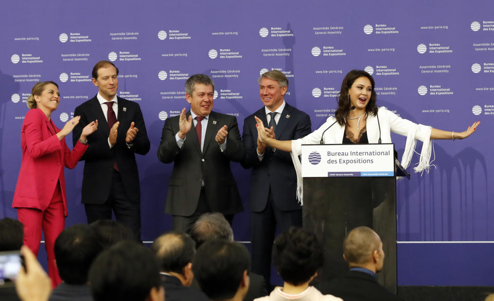 Russian delegation with Russian singer Aida Garifullina, right, and Russian Minister of Industry and Trade Denis Manturov, second left attend the 164th General Assembly of the Bureau International des Expositions (BIE) in Paris, Friday, Nov. 23, 2018. Cities in Russia, Japan and Azerbaijan are about to find out whether they can host the 2025 World Expo, an event expected to draw millions of visitors and showcase the local economy and culture. The 170 member states of the Paris-based Bureau International des Expositions are voting Friday on whether to hand the expo to Yekaterinburg, Osaka or Baku. (AP Photo/Christophe Ena)