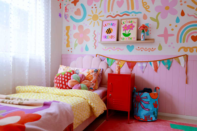 kids' room with shell headboard bed, and colorful wall mural and accents