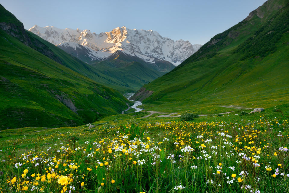 A meadow and mountains in Svaneti, Georgia.
