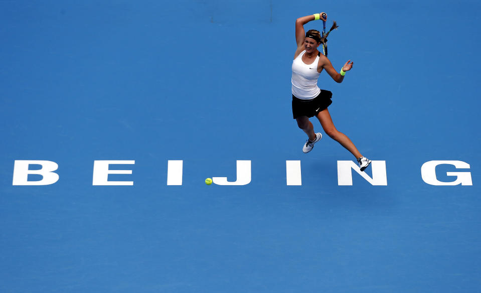 Victoria Azarenka of Belarus hits a return to Alize Cornet of France during their first round match at the China Open tennis tournament in Beijing October 1, 2012. REUTERS/David Gray (CHINA - Tags: SPORT TENNIS TPX IMAGES OF THE DAY)