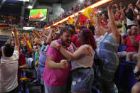 Spanish fans celebrate Spain's victory as they watch the Women's World Cup final soccer match between Spain and England on a large screen, in Madrid, Spain, Sunday, Aug. 20, 2023. (AP Photo/Paul White)