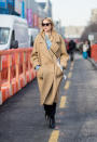 <p>This is a classic all-American look — an oversized tan coat with large lapels, layered over a chambray shirt and black jeans, and pulled together with a pair of leather boots. These are all staples you probably already have in your closet, for a look you can easily recreate. (Photo: Getty) </p>