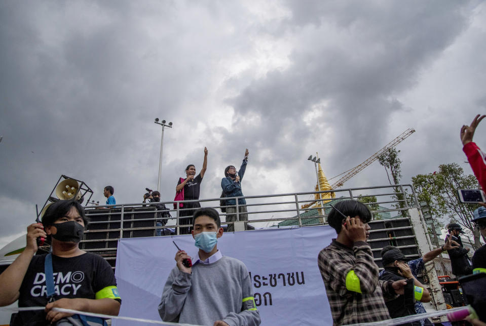 Pro-democracy demonstrators flash a three-fingered salute, the movement's symbol of resistance, from the back of a truck during a protest outside the Parliament in Bangkok, Thailand, Thursday, Sept. 24, 2020. Lawmakers in Thailand are expected to vote Thursday on six proposed amendments to the constitution, as protesters supporting pro-democratic charter reforms gathered outside the parliament building. (AP Photo/Gemunu Amarasinghe)