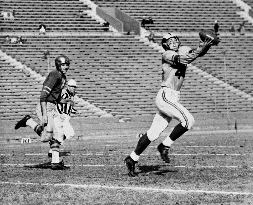 Los Angeles end Elroy Hirsch snares a pass from Bob Waterfield, good for 73 yards and a touchdown, in the first quarter of Rams game against Green Bay in 1951.