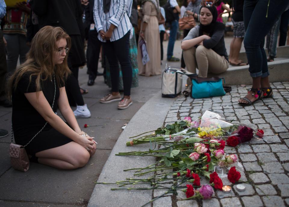 A girl prays near flowers in Washington, D.C.