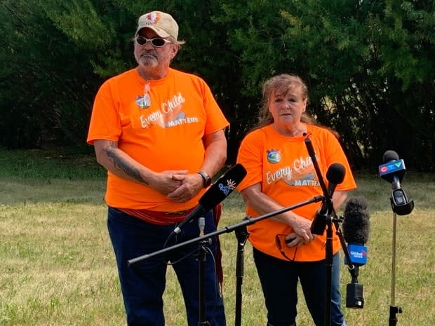 Doug Montgomery and Donna McBain own a 13-acre field on the northeast edge of the tiny hamlet of Delmas, Sask. The couple gave brief remarks in Delmas this past weekend as Battlefords Agency Tribal Chiefs began its search for unmarked graves related to a residential school in the area.  (Guy Quenneville/CBC - image credit)