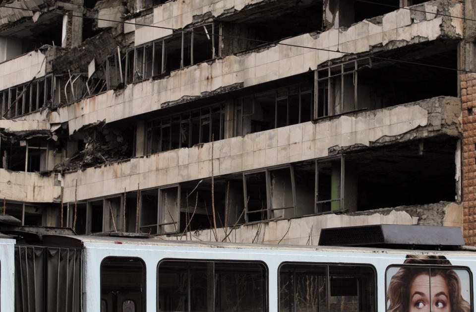 FILE- A tram car passes by former Serbian army headquarters, destroyed during NATO's bombing campaign in Belgrade, Serbia, March 24, 2013. Opposition groups in Serbia are planning protests against a real estate development project that will be financed by the firm of Donald Trump's son-in-law, Jared Kushner, at the site of the former Serbian army headquarters destroyed in a U.S.-led NATO bombing campaign in 1999. The Serbian government earlier this week signed a deal with a Kushner-related company for the 99-year lease of land in central Belgrade for the "revitalization" of the bombed-out buildings. (AP Photo/Darko Vojinovic, File)