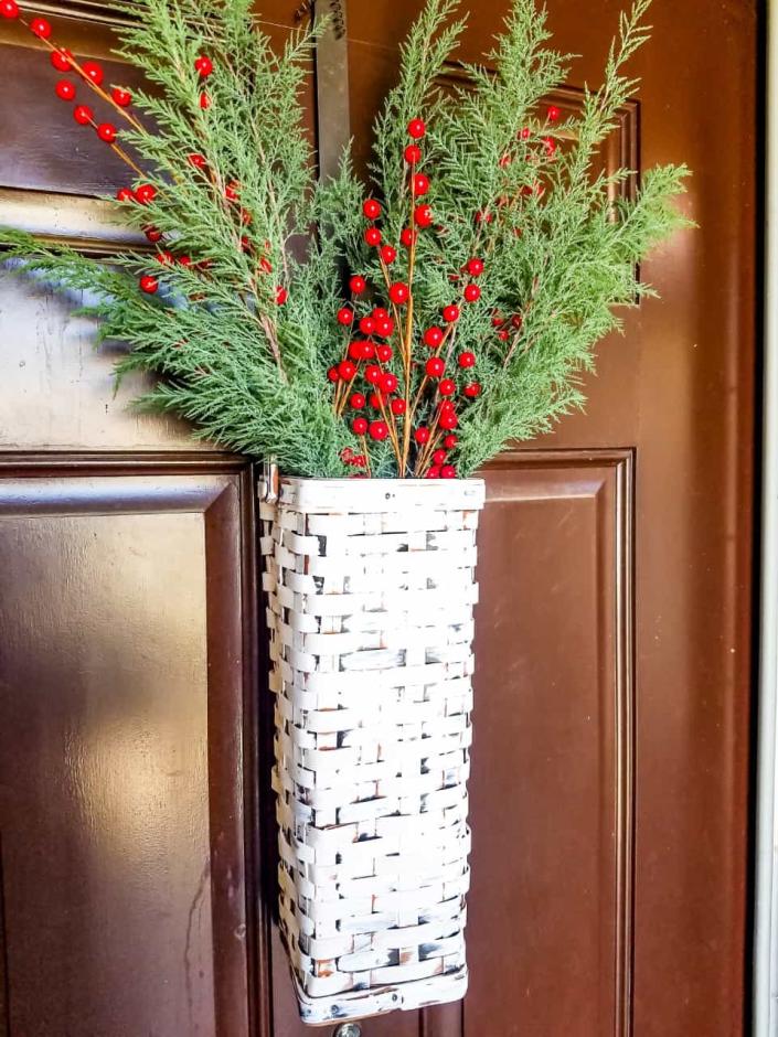 white door basket with greens and holly inside (Domestically Speaking)