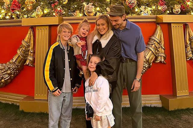 <p>Hilary Duff/ Instagram</p> Hilary Duff and her family pose in front of a Christmas tree