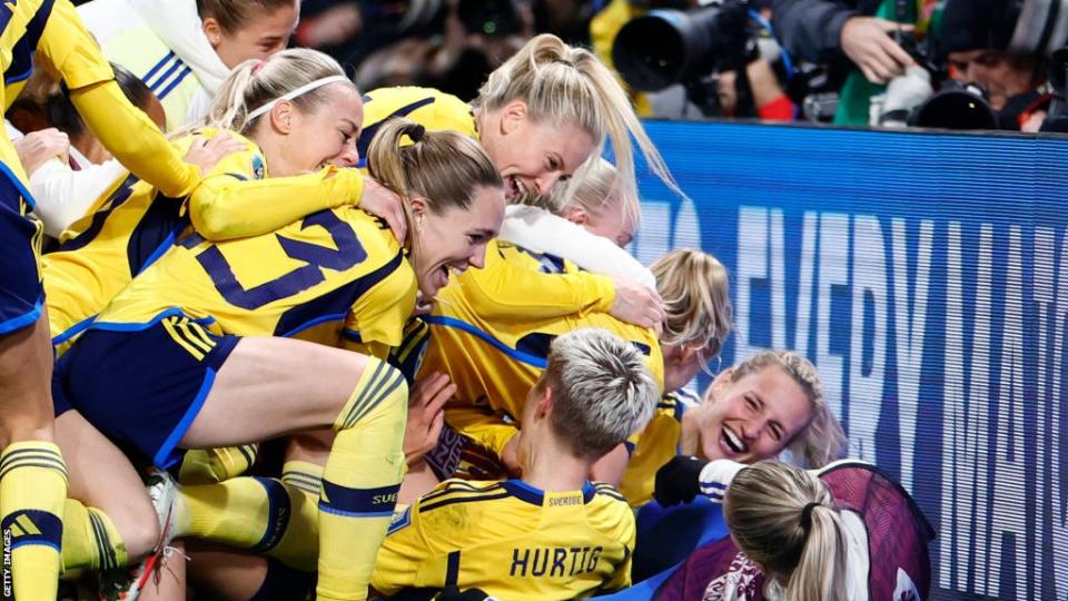 Sweden's Lina Hurtig is congratulated by team-mates after scoring the winning penalty against USA