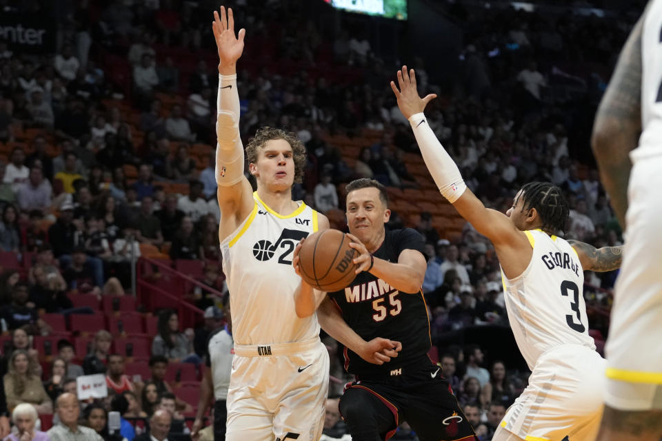 Miami Heat forward Duncan Robinson (55) drives to the basket as Utah Jazz forward Lauri Markkanen, left, and guard Keyonte George (3) defend during the first half of an NBA basketball game, Saturday, March 2, 2024, in Miami. (AP Photo/Lynne Sladky)