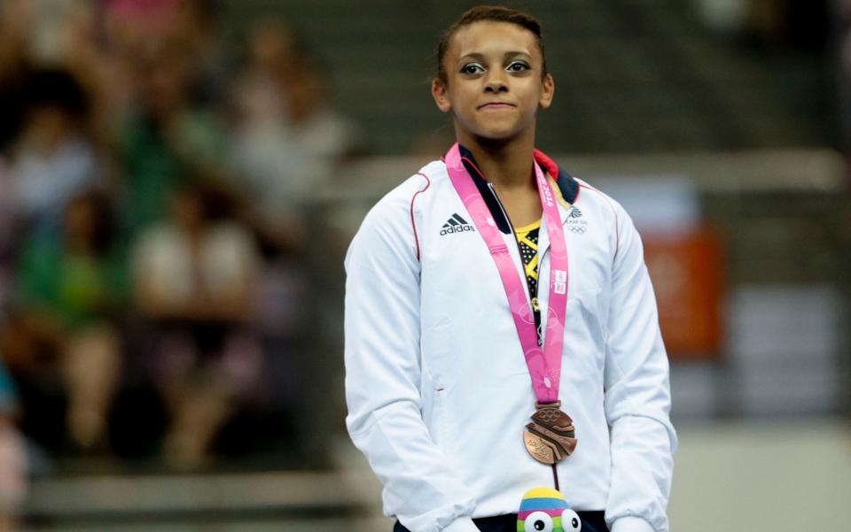 Elissa Downie of Great Britain celebrates on stage after the Women's Beam Final