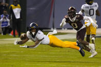 West Virginia wide receiver Winston Wright Jr. (1) tries to make a catch in front of Minnesota defensive back Justin Walley during the first half of the Guaranteed Rate Bowl NCAA college football game Tuesday, Dec. 28, 2021, in Phoenix. (AP Photo/Rick Scuteri)