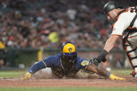 Milwaukee Brewers' Jonathan Davis scores next to San Francisco Giants catcher Joey Bart on a single by Willy Adames during the sixth inning of a baseball game in San Francisco, Thursday, July 14, 2022. (AP Photo/Godofredo A. Vásquez)