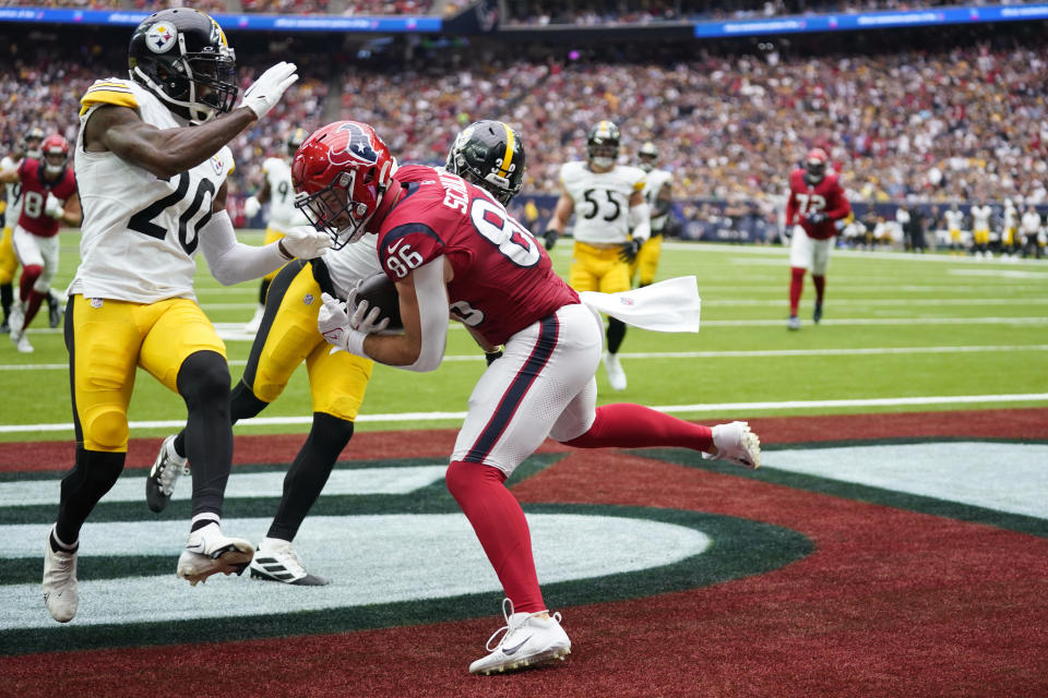 Houston Texans tight end Dalton Schultz (86) catches a pass for a touchdown in front of Pittsburgh Steelers cornerback Patrick Peterson (20) and safety Minkah Fitzpatrick (39) during the second half of an NFL football game Sunday, Oct. 1, 2023, in Houston. (AP Photo/Eric Christian Smith)