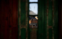 Houses are seen through a window of Tiki hostel in Cantagalo favela, in Rio de Janeiro, Brazil, April 15, 2016. REUTERS/Pilar Olivares