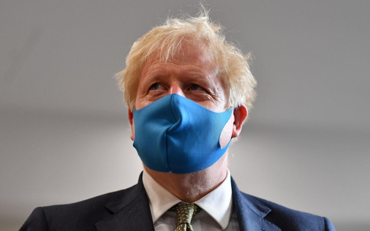 Ahead of the announcement the Prime Minister wore a face mask during a visit to the London Ambulance Service NHS Trust on Monday - AFP