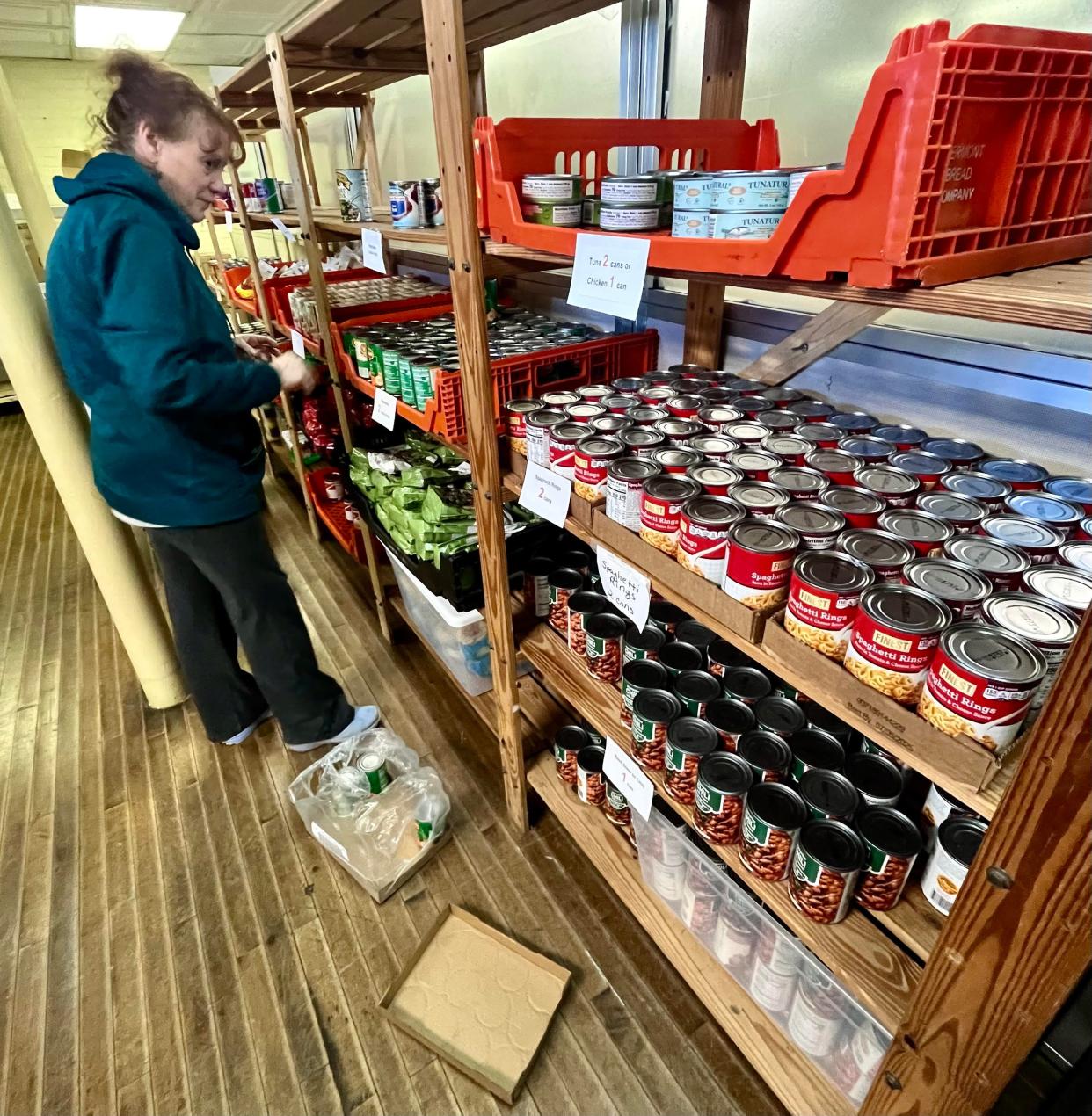 Volunteer Sheila Lynds is seen here on Saturday, March 16, 2024, checking inventory of canned goods at the Matthew Mission food pantry in Taunton.