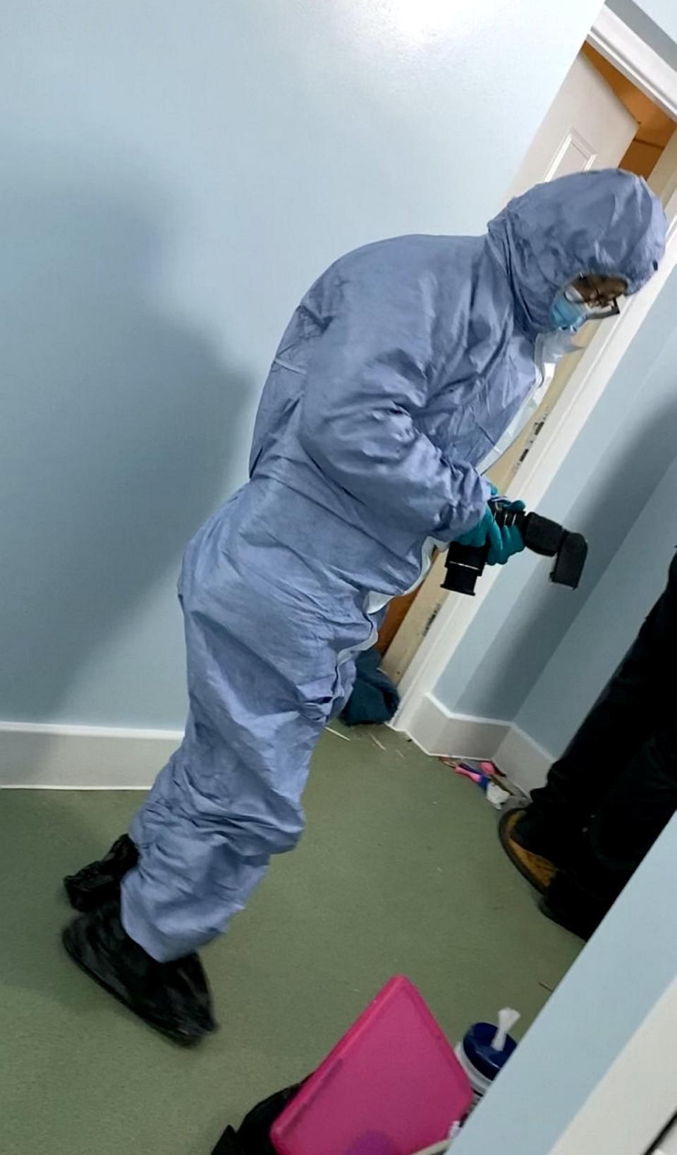 A forensic officer attending the property (SWNS)