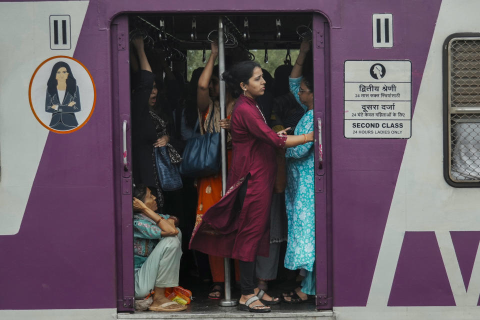 Indian women travel in the ladies compartment of a local train in Mumbai, India, Tuesday, July 23, 2024. India’s finance minister Nirmala Sitharaman on Tuesday unveiled the first full annual budget of the newly elected government following the national election. (AP Photo/Rafiq Maqbool)