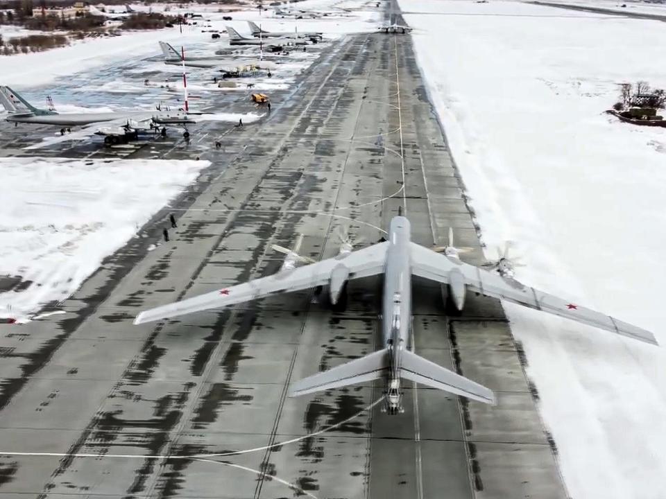 In this image taken from video provided by the Russian Defense Ministry Press Service, a Tu-95 strategic bomber of the Russian air force prepares to take off from an air base in Engels near the Volga River in Russia, Monday, Jan. 24, 2022.