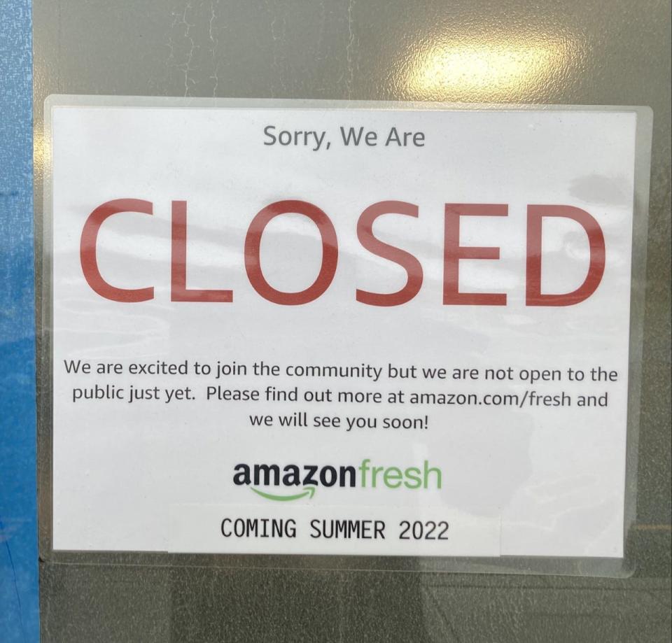 A sign on the door of the Amazon Fresh supermarket in Paramus indicates the store will open in summer