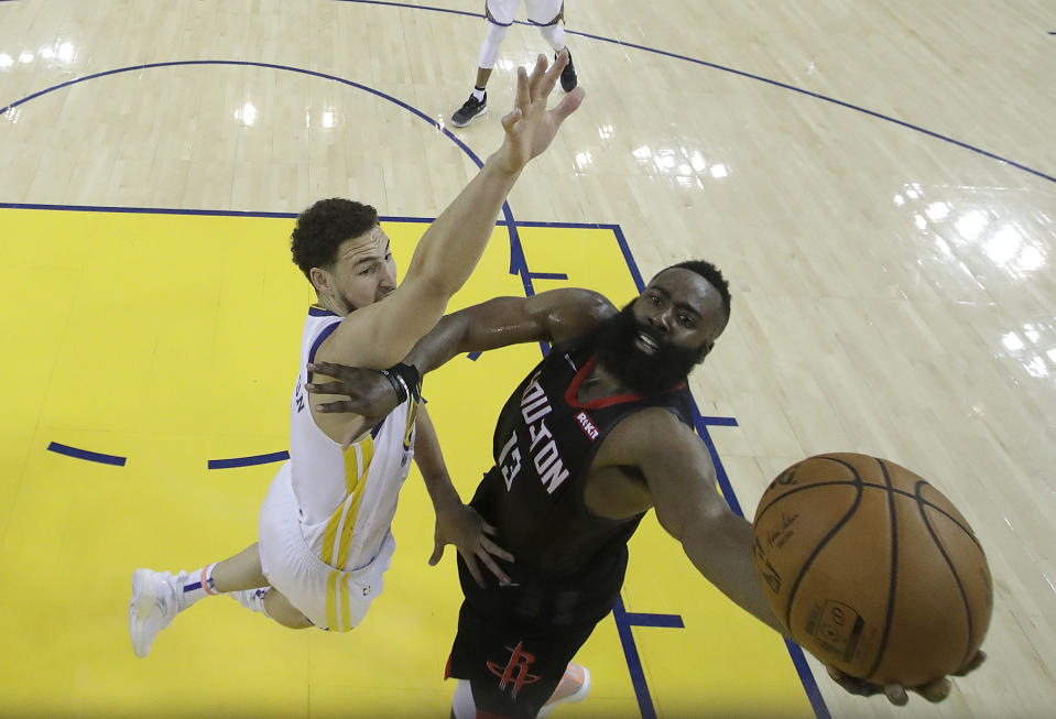 Houston Rockets guard James Harden, right, shoots against Golden State Warriors guard Klay Thompson during the second half of Game 1 of a second-round NBA basketball playoff series in Oakland, Calif., Sunday, April 28, 2019. (AP Photo/Jeff Chiu, Pool)