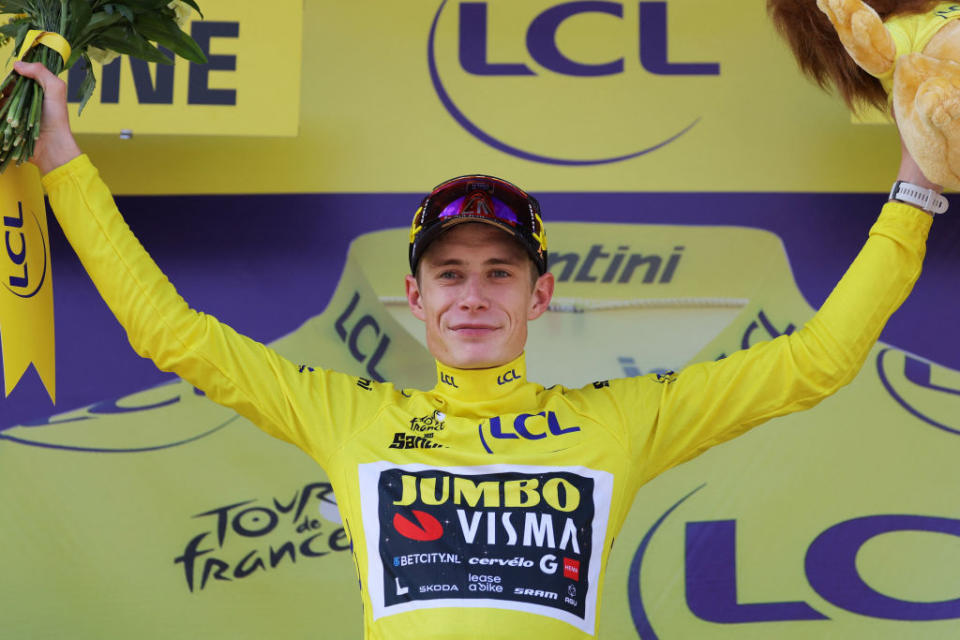 Jumbo-Visma's Danish rider Jonas Vingegaard celebrates on the podium with the overall leader's yellow jersey after the 14th stage of the 110th edition of the Tour de France cycling race, 152 km between Annemasse and Morzine Les Portes du Soleil, in the French Alps, on July 15, 2023. (Photo by Thomas SAMSON / AFP)