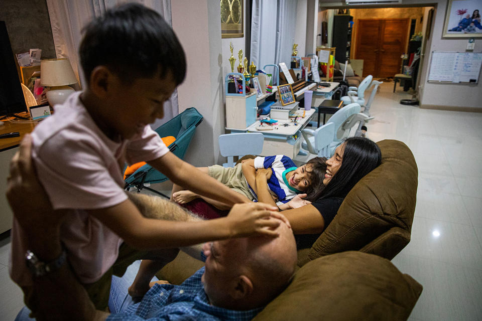 Gina and Lee with their children Chene and Charlie, in their family home.<span class="copyright">Lauren DeCicca for TIME</span>