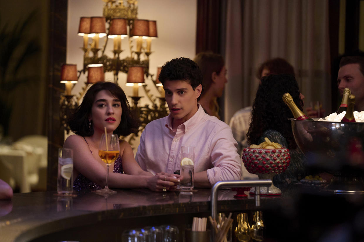 Adam DiMarco as Albie Di Grasso and Simona Tabasco as Lucia Greco having a drink at a bar in 