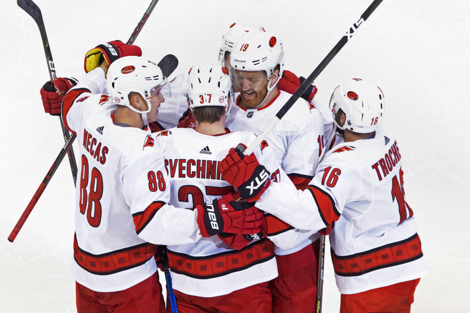 Carolina Hurricanes' Dougie Hamilton (19) celebrates his goal against the Boston Bruins with teammates Martin Necas (88), Andrei Svechnikov (37) and Vincent Trocheck (16) during the third period of an NHL Eastern Conference Stanley Cup hockey playoff game in Toronto, Thursday, Aug. 13, 2020. (Chris Young/The Canadian Press via AP)